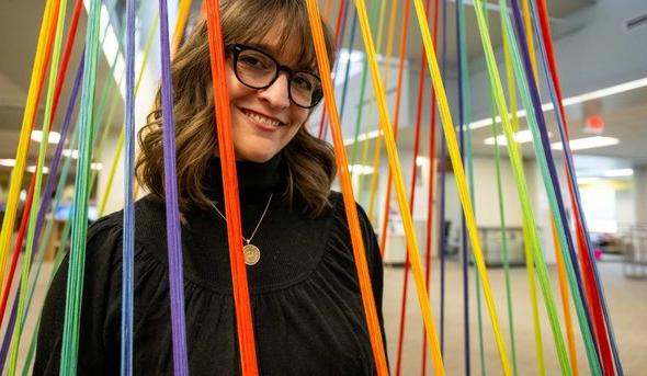 Kim McCoy stands inside her art installation.